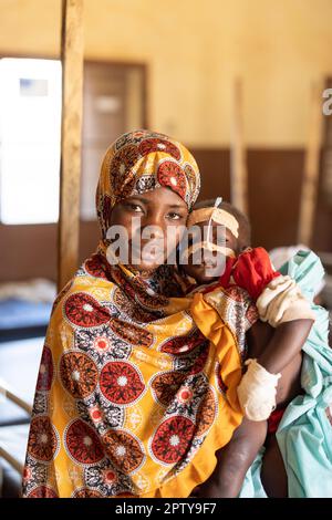 Mother and young child admitted to hospital for malnutrition and malaria in Segou Region, Mali, West Africa. 2022 Mali drought and hunger crisis. Stock Photo