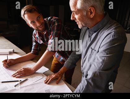 Turning his vision into reality. An architect drawing up plans Stock Photo