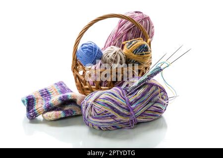 Colored threads, knitting needles and other items for hand knitting, isolated on a white background. Stock Photo