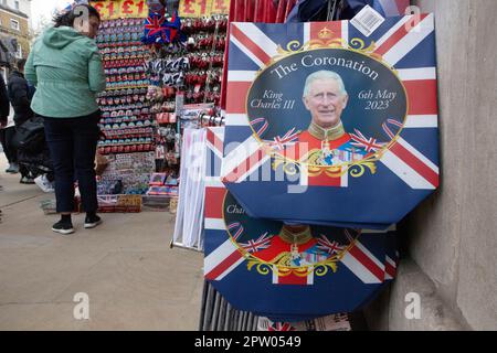 London, UK. 27th Apr, 2023. In central London stalls sell souvenirs for tourists which commemorate the upcoming coronation of King Charles III. from bags and flags to mugs and cuddly toys, it is hoped that the coronation will bring an influx of tourists and a boost to the economy. Credit: Anna Watson/Alamy Live News Stock Photo
