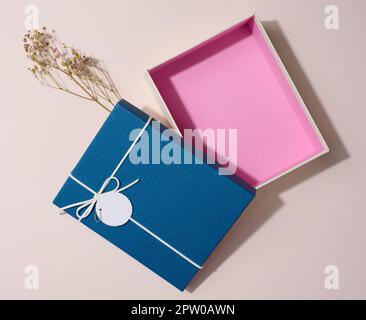 Empty open rectangular gift cardboard box on beige background, top view Stock Photo