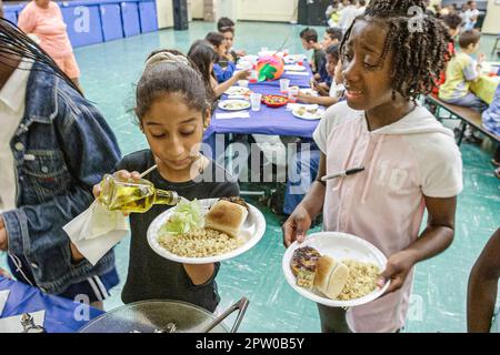 Miami Florida,Frederick Douglass Elementary School campus primary,inner city school cafeteria picnic lunch,student students girl girls female Black Af Stock Photo