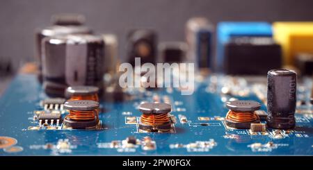 Electronic components background. Close up of coils on industrial circuit board. Stock Photo