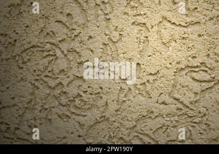 The texture of the beige decorative plaster in bark beetle style. Russian variation of decorating facade walls Stock Photo