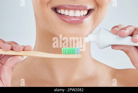 For the perfect smile. an unrecognizable young woman posing in studio against a grey background Stock Photo