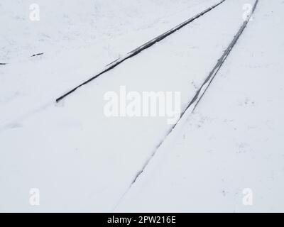 Railway in the snow. Rails covered by a snowstorm. Railway service, snow removal. Transport concept. Snowdrifts and drifts. Difficult weather conditio Stock Photo