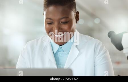 Research gets me excited. an attractive young scientist sitting alone in her laboratory and using her laptop Stock Photo