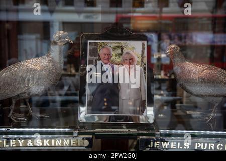 London, UK. 28th Apr 2023. A photo of King Charles III and Queen Camilla is displayed in a shop window, ahead of their coronation on May 6th, 2023. Credit: Kiki Streitberger /Alamy Live News Stock Photo