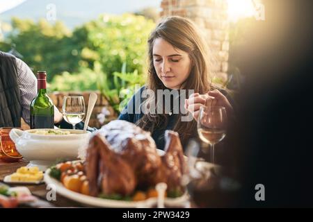 Family, food and prayer at table, hand holding and praying before sharing meal on patio, blessing and gratitude. Pray, hands and woman in thanksgiving Stock Photo