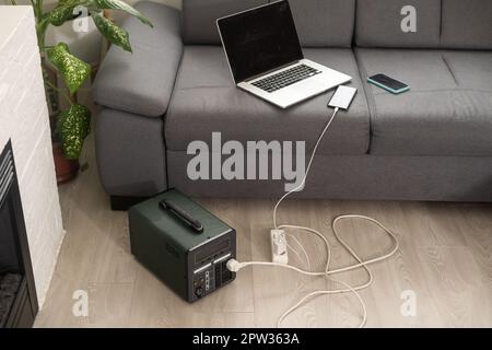 The inverter generator charges the power bank battery Stock Photo