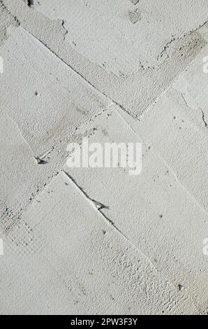 The texture of the wall, covered with gray foam polystyrene plates, which are smeared with a reinforcing mixture. Stage of wall insulation Stock Photo
