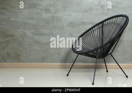 Metal Chair Lined In Black Rattan; Photo On Gray Background Stock Photo