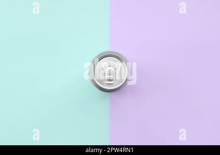 Metallic beer can on texture background of fashion pastel violet and blue colors paper in minimal concept. Stock Photo