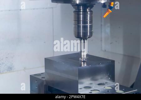 CNC machine tool cutting raw material in factory Stock Photo