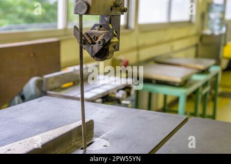 Old jig Saw table holding manual jig saw Stock Photo