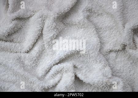 White natural cotton towel background texture with many folds in daylight Stock Photo