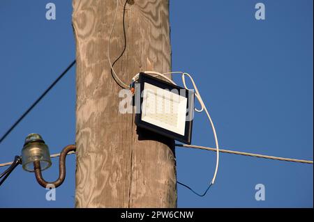 The LED street light is attached to a wooden pole. High quality photo Stock Photo