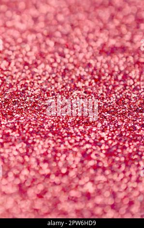Coral red decorative sequins. Background image with shiny bokeh lights from small elements that reflect light Stock Photo