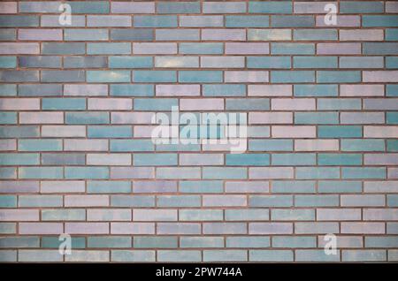 The texture of wall from a variety of old and dirty brick. Detailed pattern of a plurality of different sizes of brick colored worn out Stock Photo
