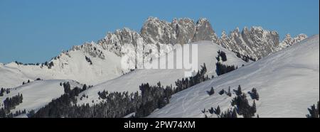 Snow covered hills and Gastlosen mountain range. Stock Photo