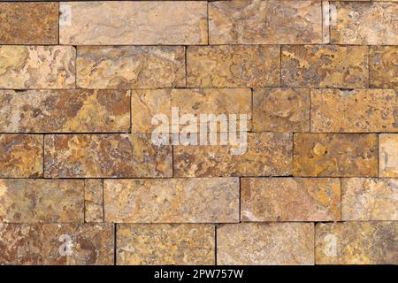 Rust-colored sandstone wall. Natural, rustic style construction. Stock Photo