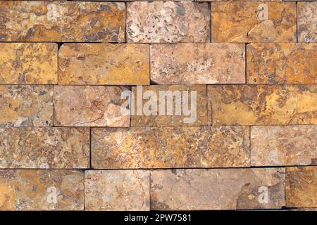 Rust-colored sandstone wall. Natural, rustic style construction. Stock Photo