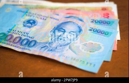 Banking, investment in Vietnam. Vietnamese currency with the image of Ho Chi Minh on it, on top of other vietnamese banknotes. Stock Photo