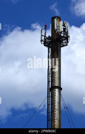 Tower With A Pipe And A Ladder Against A Blue Sky And Clouds Stock 