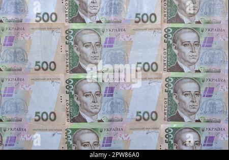 A close-up of a pattern of many Ukrainian currency banknotes with a par value of 500 hryvnia. Background image on business in Ukraine Stock Photo