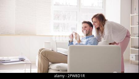 Portrait Of Couple Doing Home Finance With Calculator Stock Photo