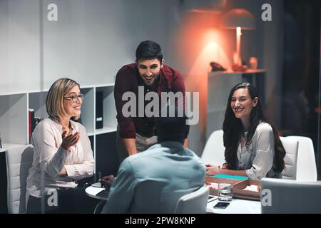 The team with the do it mindset. colleagues having a meeting during a late night in a modern office. Stock Photo