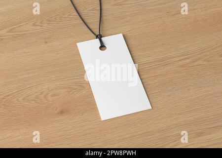 White rectangular tag mockup on wooden background. Side view Stock Photo