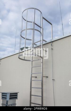 Technical access to the higher part of the roof via a stainless steel ladder. Stock Photo