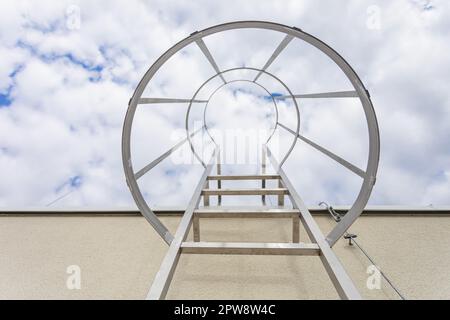 View from below of the technical ladder leading to the building's roof. Stock Photo