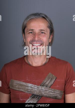 Caucasian mature male portrait. Male with yellow teeth. Smiling man with unhealthy teeth.Messy hair man Stock Photo