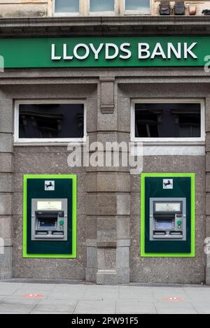 Twin ATM or cash machines outside of a Lloyds bank in Brighton, England.  April 2023 Stock Photo