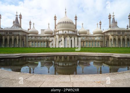 Exterior of Brighton's Royal Pavilion with reflections from a pond in front of it. April 2023 Stock Photo