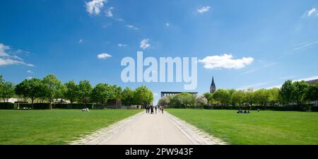 Grounp of people walking and enjoying Breche Gardens  on a sunny day, Niort, France Stock Photo