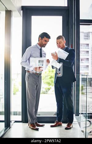 What do you make of this. two businessmen having a discussion in an office. Stock Photo