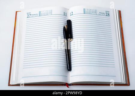 Open notebook with pen on white background. business and education concept. Stock Photo