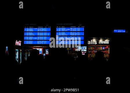 Timetable electronic board , snacks kiosk and people silhouettes in Northern Railway Station in Bucharest, Romania on November 2022 Stock Photo