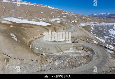 (230429) --  KHUNJERAB, April 29, 2023 (Xinhua) -- This aerial photo shows soldiers patrolling in a car in Khunjerab, northwest China's Xinjiang Uygur Autonomous Region, April 14, 2023. Gao Guanghui, a recruit who had just joined the army for 7 months, was shocked when he walked into the honor room of the border defense regiment in Khunjerab, northwest?China's Xinjiang Uygur Autonomous Region.    The regiment is based on the Pamirs, guarding the China-Pakistan border and Khunjerab Port. With an average altitude of 4,700 meters, the place is a 'forbidden zone' for many people, as the temperatur Stock Photo