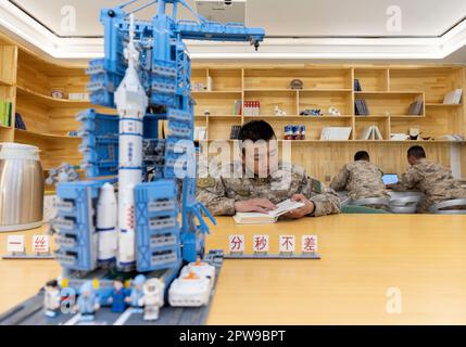 (230429) --  KHUNJERAB, April 29, 2023 (Xinhua) -- Soldiers read books in a reading room at the barrack in Khunjerab, northwest China's Xinjiang Uygur Autonomous Region, April 13, 2023. Gao Guanghui, a recruit who had just joined the army for 7 months, was shocked when he walked into the honor room of the border defense regiment in Khunjerab, northwest?China's Xinjiang Uygur Autonomous Region.    The regiment is based on the Pamirs, guarding the China-Pakistan border and Khunjerab Port. With an average altitude of 4,700 meters, the place is a 'forbidden zone' for many people, as the temperatur Stock Photo