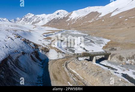 (230429) -- KHUNJERAB, April 29, 2023 (Xinhua) -- This aerial photo shows soldiers patrolling in a car in Khunjerab, northwest China's Xinjiang Uygur Autonomous Region, April 14, 2023. Gao Guanghui, a recruit who had just joined the army for 7 months, was shocked when he walked into the honor room of the border defense regiment in Khunjerab, northwest?China's Xinjiang Uygur Autonomous Region. The regiment is based on the Pamirs, guarding the China-Pakistan border and Khunjerab Port. With an average altitude of 4,700 meters, the place is a 'forbidden zone' for many people, as the temperatur Stock Photo