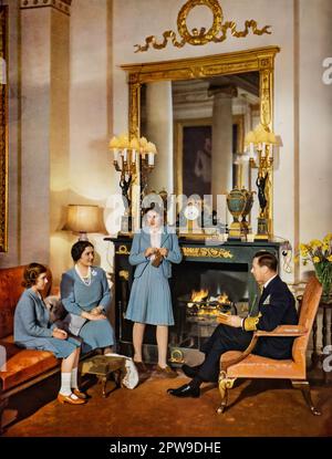 A Royal Family Scene, King George V1 Of Great Britain, The Queen and the future Queen, 16 year Princess Elizabeth seen here knitting, and 11 year old Princess Margaret, photographed in 1942, in a specially commissioned natural colour photograph to mark the centenary of the Illustrated London News Stock Photo
