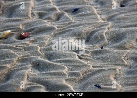 Shapes in the sand, created by the ocean waves Stock Photo