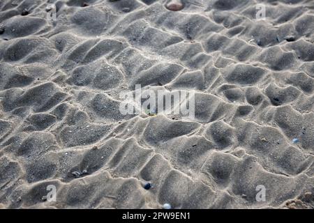 Shapes in the sand, created by the ocean waves Stock Photo