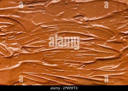 Chocolate background. Melted chocolate. Liquid milk chocolate. Handmade chocolate. Stock Photo