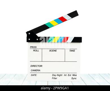 Film slate or Flying clapperboard on wooden table isolated on white background, Save clipping path. Stock Photo