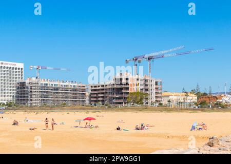 cranes by Hotels under construction by the beach near Villamoura Algarve Portugal Stock Photo